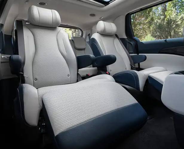 The luxury second row of the 2026 Kia Carnival with plush white captain's chairs